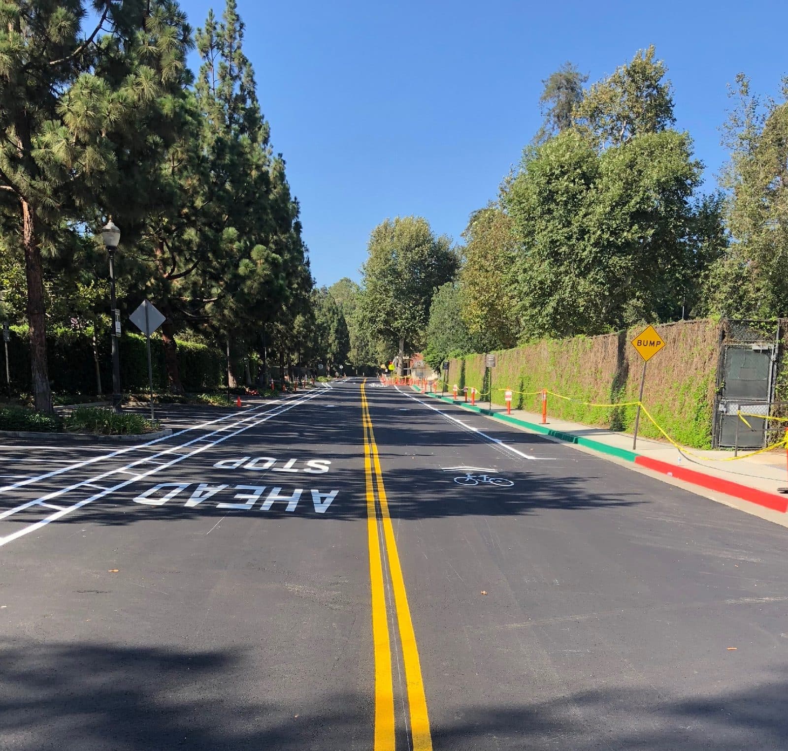 Roadway striping with double-yellow lines and a thermoplastic stop bar
